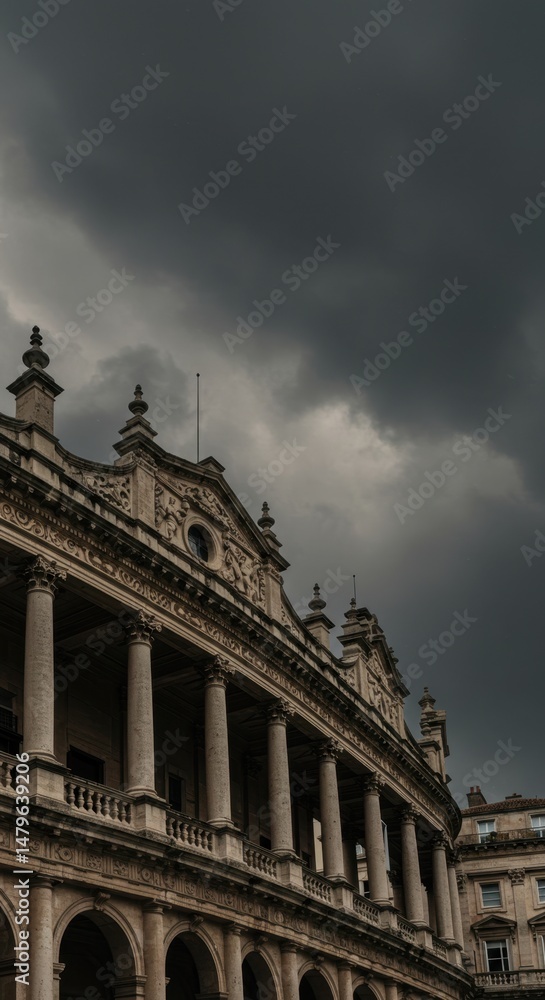 Fototapeta premium Dramatic stormy sky over classical European building with ornate columns and architecture. Moody atmospheric cityscape showcasing historical landmark in ominous weather