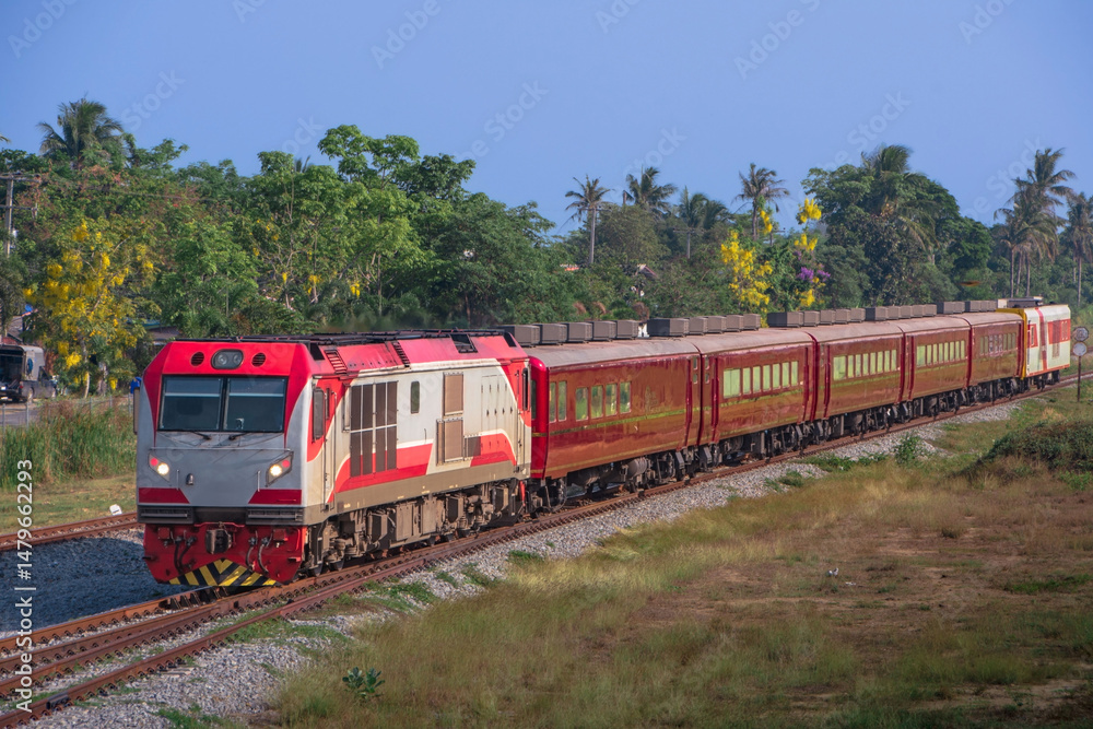 Naklejka premium Passenger train by diesel locomotive on the railway in Thailand.