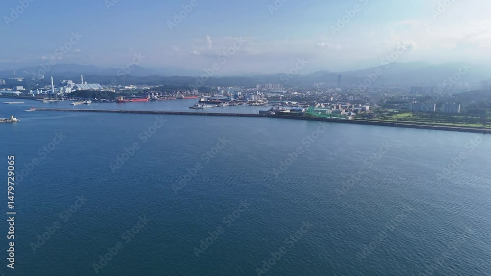 Drone view of anchored cargo ships and industrial complex near Donghae Port, Gangwon Province Drone view of anchored cargo ships and industrial complex near Donghae Port, Gangwon Province