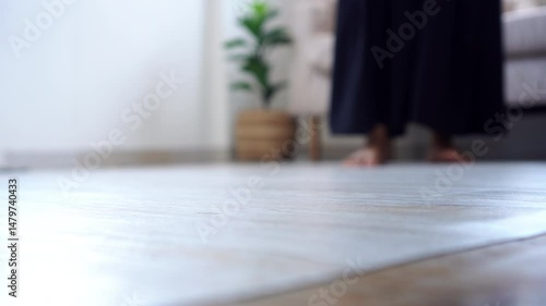 Woman passing out and falling down from fainting on the floor, possibly caused by hypotension, heart issues, or syncope, with signs of dizziness and losing balance