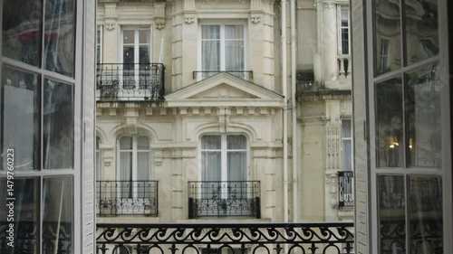 Elegant building facade seen through window with curtain