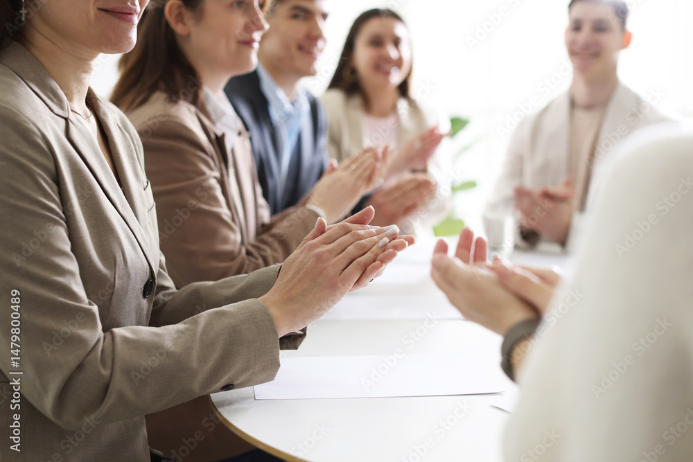 Fototapeta premium People applauding at table in office, closeup