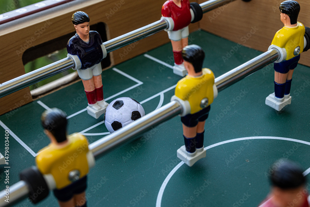 Fototapeta premium A close-up shot of a foosball table game in action. Perfect for sports, leisure, and competition concepts.