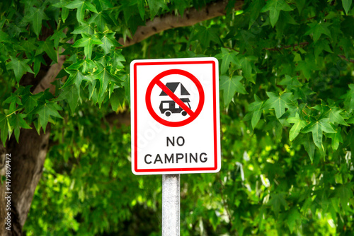 No camping parking sign in public park.