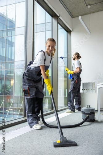 Housekeeping team cleaning the conference room and looking busy and involved