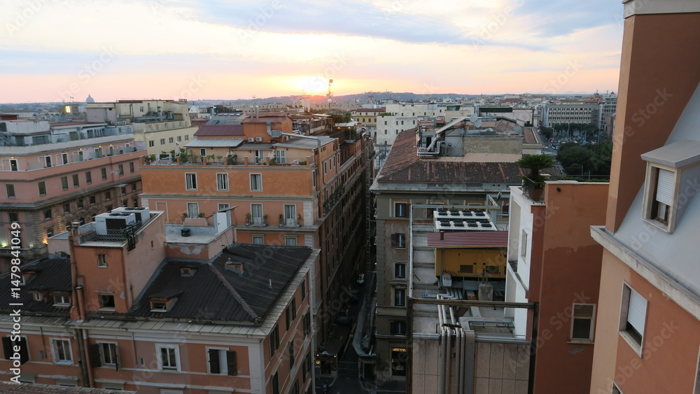 Naklejka premium Stunning sunset view over the rooftops of Rome, Italy. Historic buildings and cityscape at golden hour.