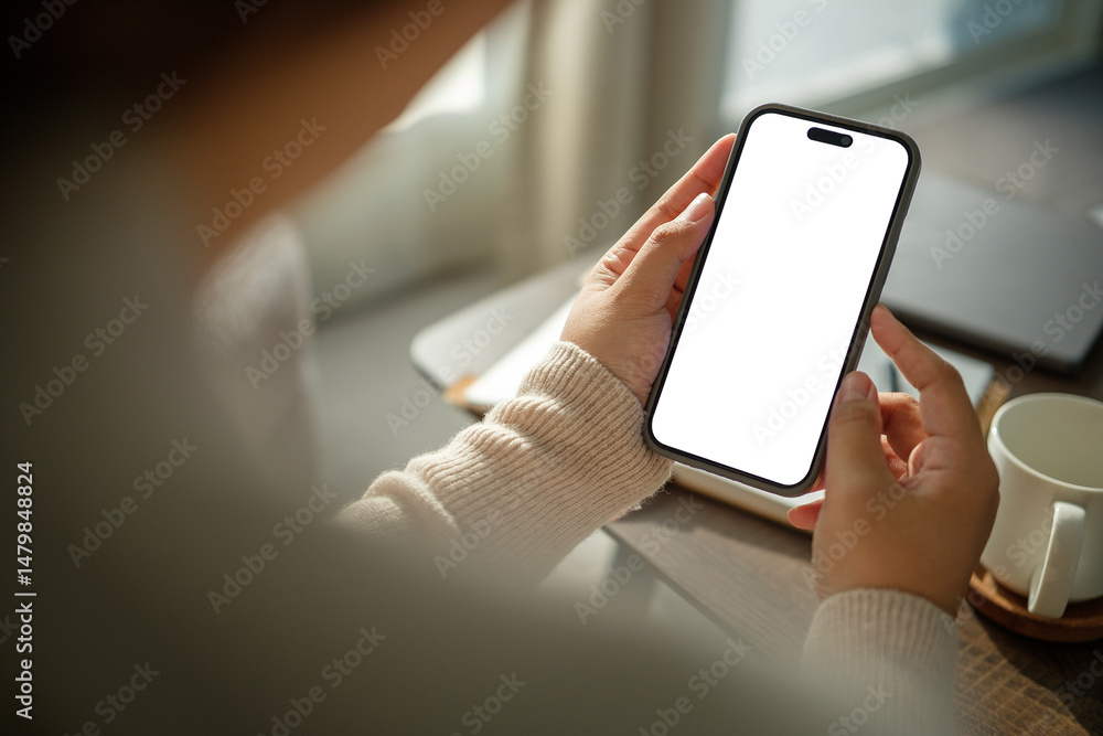 Female hand using mobile phone with empty screen, for showcasing mobile apps or advertising layouts. Female hand using mobile phone with empty screen, for showcasing mobile apps or advertising layouts.