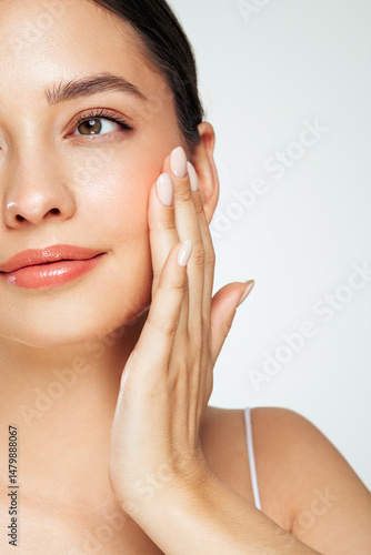 Wallpaper Mural Skin care. Woman with beauty face touching healthy facial skin portrait. Beautiful girl model with natural makeup touching glowing hydrated skin on white background closeup Torontodigital.ca