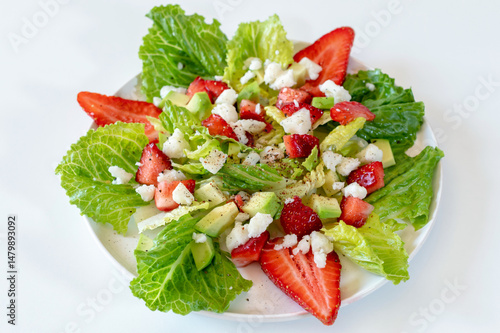 Salad with strawberries, avocado and goat cheese.