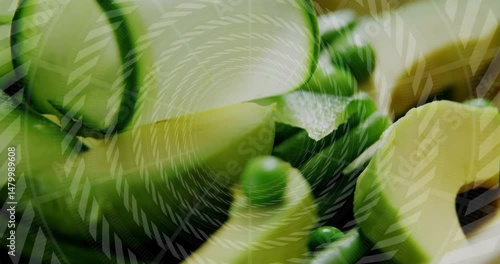 Curved green tubes spinning around center, with small pea spheres and translucent spiral overlay