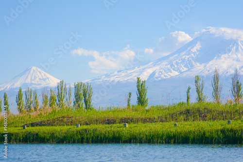 Mount Ararat, scenic nature view from Armenia. Beautiful volcanic mountain with view of lake and forests. Natural landscape with mountain and river.