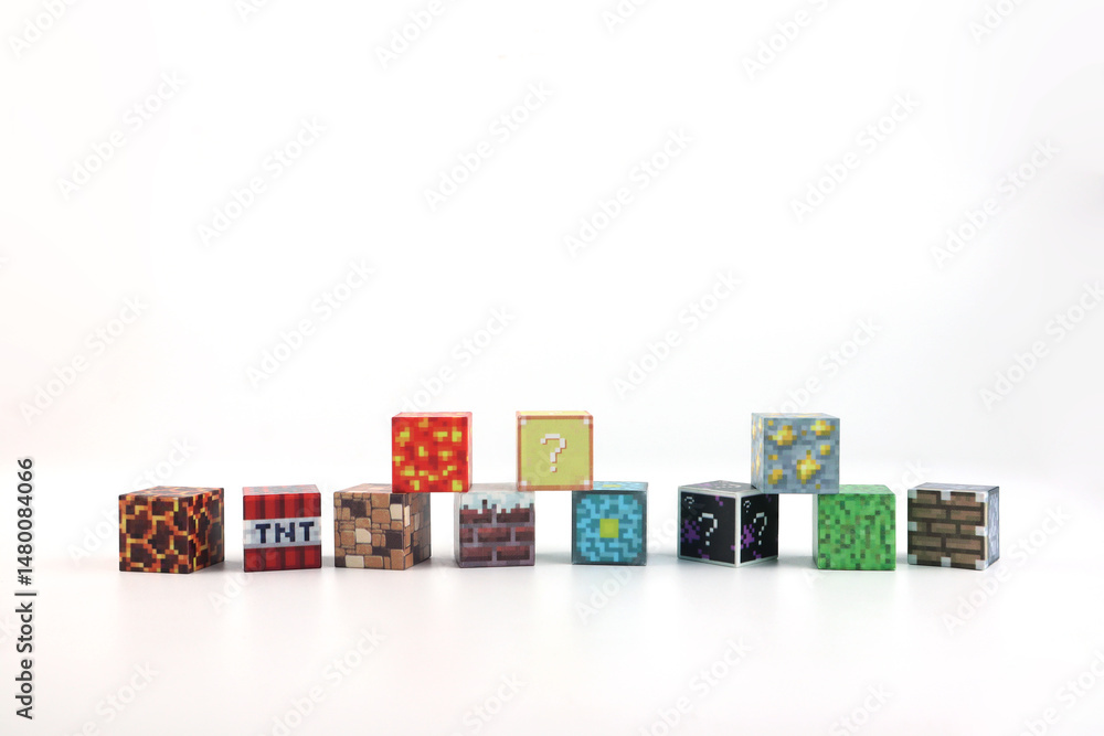Naklejka premium minecraft magnetic building toy blocks , from online virtual world game series are display on white table with many kinds of minecraft blocks , tnt magma stone wood grass water and cute characters