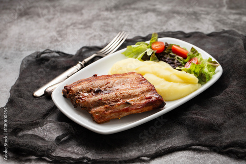 Braised ribs with potato puree and salad