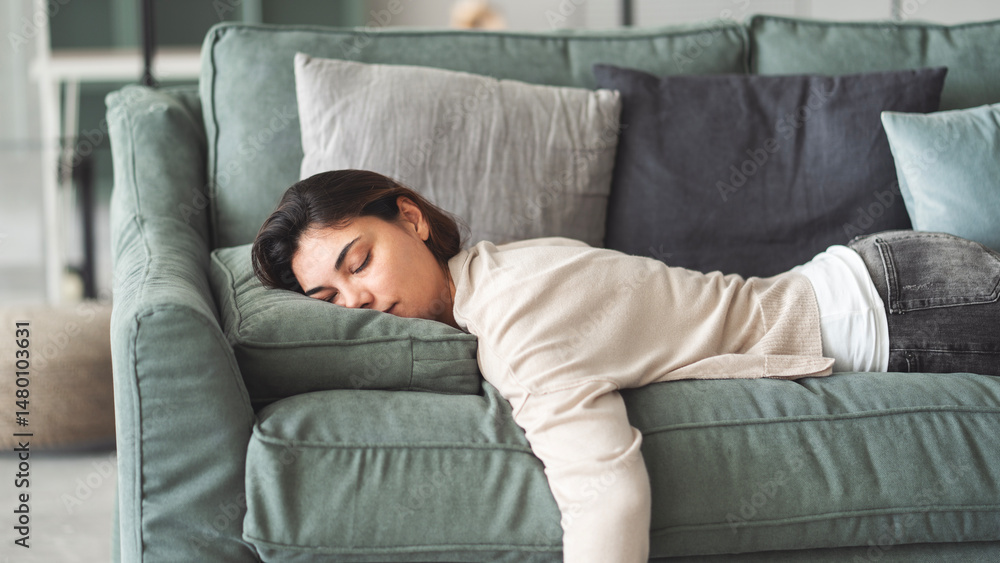 Exhausted young woman resting at home on couch Exhausted young woman resting at home on couch