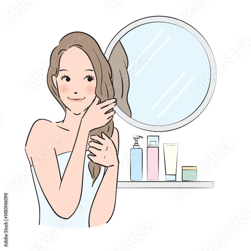 丁寧にヘアケアをするロングヘアの女性