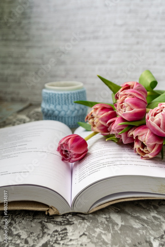 Pink tulips, an open book and a mug of freshly brewed coffee or tea. Spring set. Flatley layout.