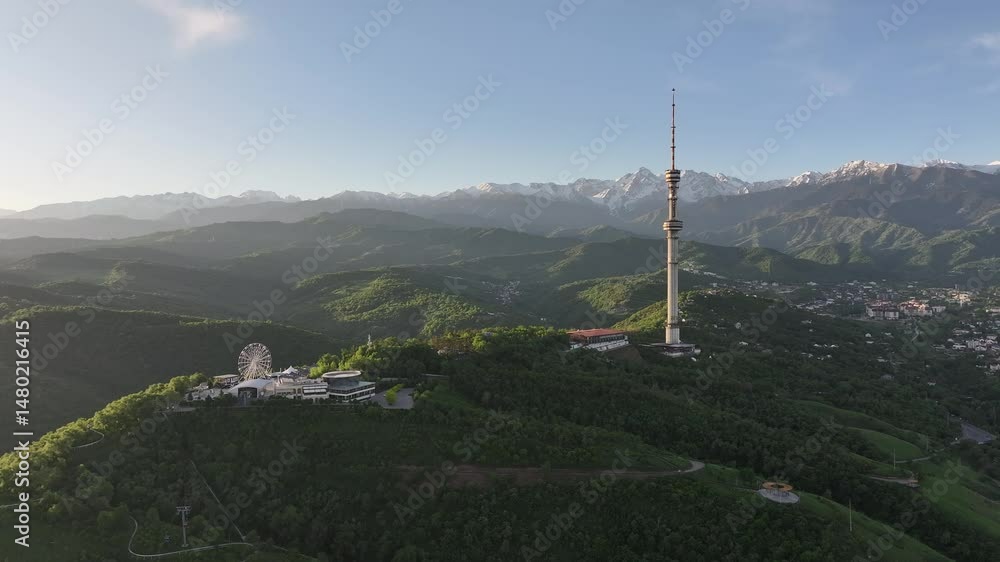 Mount Kok Tobe (Blue Hill) with the famous TV tower against the backdrop of the Zailiyskiy Alatau mountain range in the Kazakh city of Almaty on an early spring morning Mount Kok Tobe (Blue Hill) with the famous TV tower against the backdrop of the Zailiyskiy Alatau mountain range in the Kazakh city of Almaty on an early spring morning
