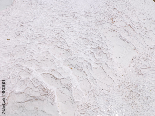 Pamukkale, the cotton castle and cotton hill, white travertine natural hot spring and ancient Roman Greek bath house at Hierapolis ruins site, Izmir, Turkiye 