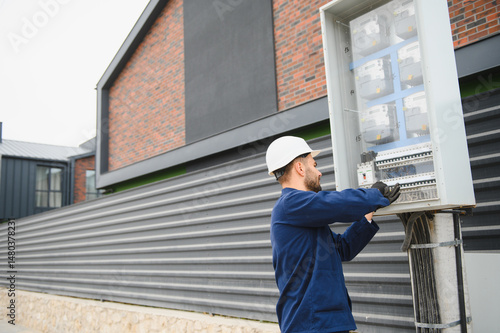 Wallpaper Mural Electrical engineer approving power distribution box installation on site Torontodigital.ca