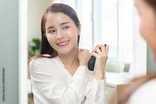 Free Download Perfume of essential aroma, beauty fashion concept. attractive perfect asian young woman holding perfume bottle, using spray and applying fragrance, scent at neck on body in front of mirror at home. - GFXLoad