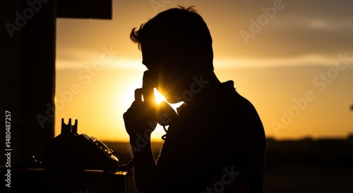 Silhouette of Person on Phone at Sunset - Photo