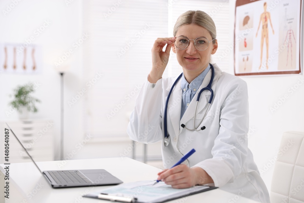 Professional doctor working at desk in hospital. Space for text Professional doctor working at desk in hospital. Space for text