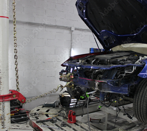 Frame Tilting Machine Repair the Damaged Sedan. Machine Straightens Bent Car Body After Accident. Slipway for Vehicle Repairs in Car Workshop
