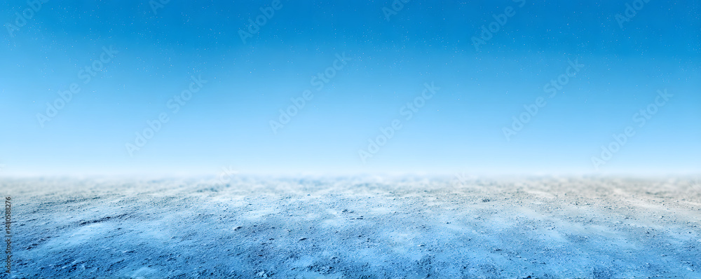 Fototapeta premium Vast barren landscape under a bright blue sky with minimal clouds during midday sunlight