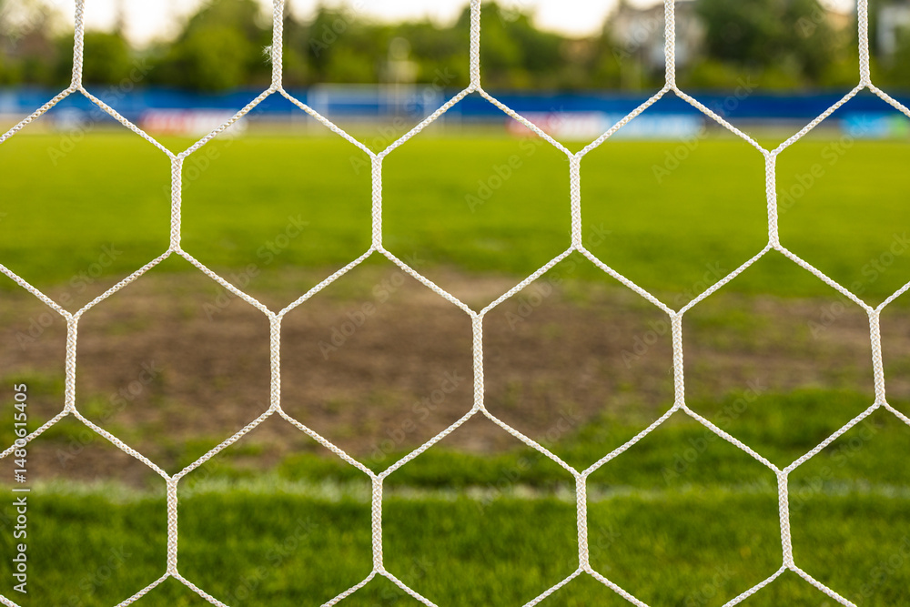 Fototapeta premium Close-Up of Soccer Net on Green Grass – Detail of Football Goal and Sports Concept