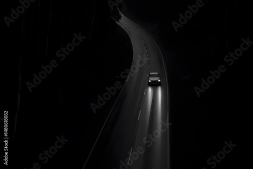 Solitude on the Road: A solitary car glides through a winding asphalt road, its headlights slicing through the dark night, leaving a trail of luminescence in its wake.