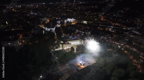 Fireworks over cityscape, high angle, shot with drone.