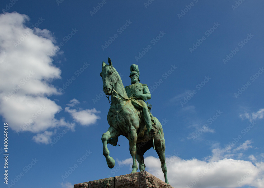 Equestrian statue of a historical figure against a bright blue sky with scattered clouds. Classic monument symbolizing leadership, history, and heritage. Equestrian statue of a historical figure against a bright blue sky with scattered clouds. Classic monument symbolizing leadership, history, and heritage.
