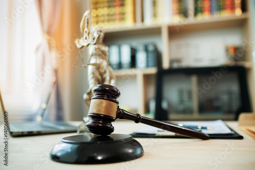 Fotografie Lady Justice, scales, and a gavel placed on a judge’s desk represent fairness and integrity in law and courtroom proceedings