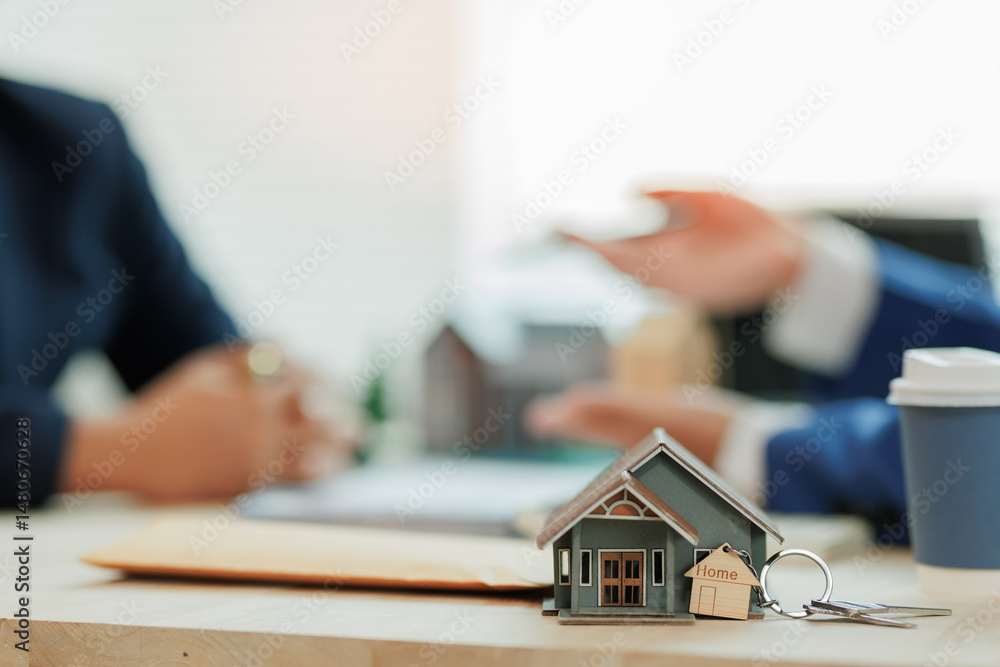 Real estate agent presenting a model home to a client as a housing option, highlighting guidance and property selection support.