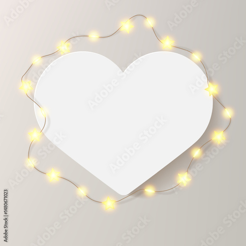 Heart shape picture frame. White card with wreath of shiny star light bulbs. Love message, birthday congrats, soft beige festive luxury bg. Realistic photo mockup, decorated with Christmas garland