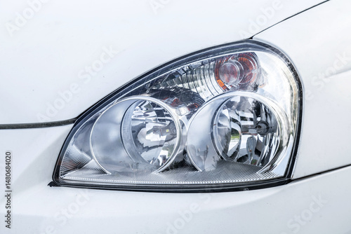The headlight of a car is clean and shiny
