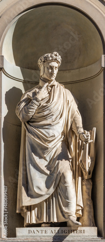 FLORENCE, ITALY - MARCH 18, 2025: The statue of Dante Alighieri on the facade of Uffizi gallery by Emilio Demi (1798 – 1863).