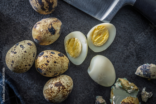 Boiled quail eggs on black table. Top view.