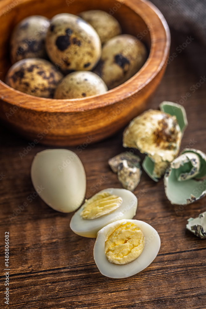 Boiled quail eggs on wooden table.