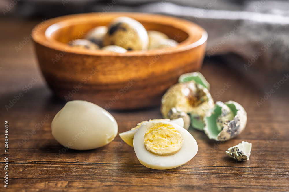 Boiled quail eggs on wooden table.