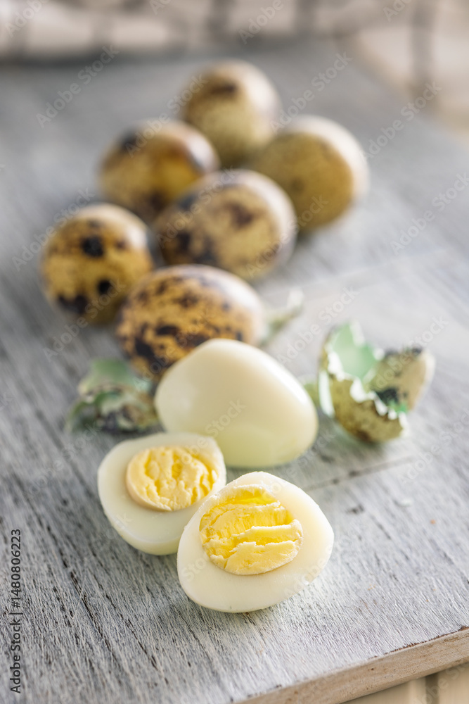 Boiled quail eggs on cutting board.
