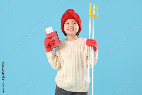 Little Asian girl with skis...