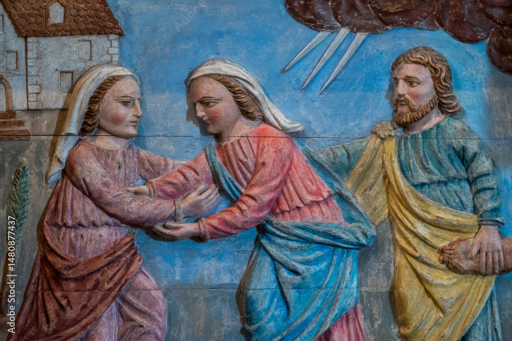 Naklejka premium Wood bas relief (19th century) of Visitation of the Virgin Mary to her pregnant cousin Elizabeth.