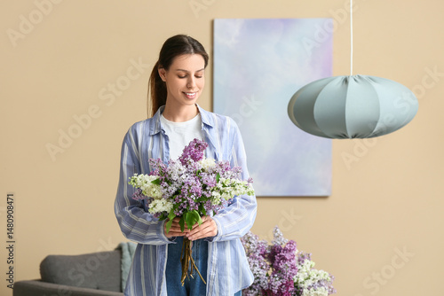 Smiling young woman holding...