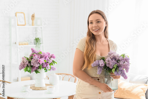 Young woman holding vase wi...