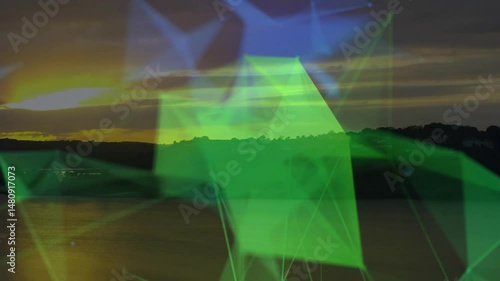 Network of green glowing triangles floating over lake sunset featuring translucent connecting lines