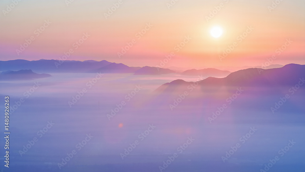 Fototapeta premium Sunrise over misty mountains with a soft glow illuminating the natural landscape beauty