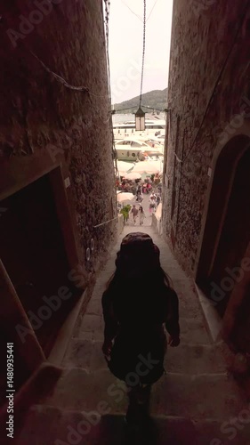 Young Woman Walking Through Picturesque Streets of Cinque Terre, Italy, Rear View in Colorful Mediterranean Village