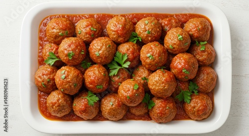 Meatballs in Tomato Sauce on a White Tray with Fresh Parsley from Top View for Culinary Dinner