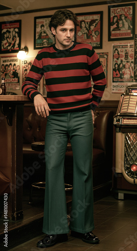 Man in striped sweater and flared pants poses nonchalantly in a bar with jukebox and vintage posters. Style, music and nostalgia